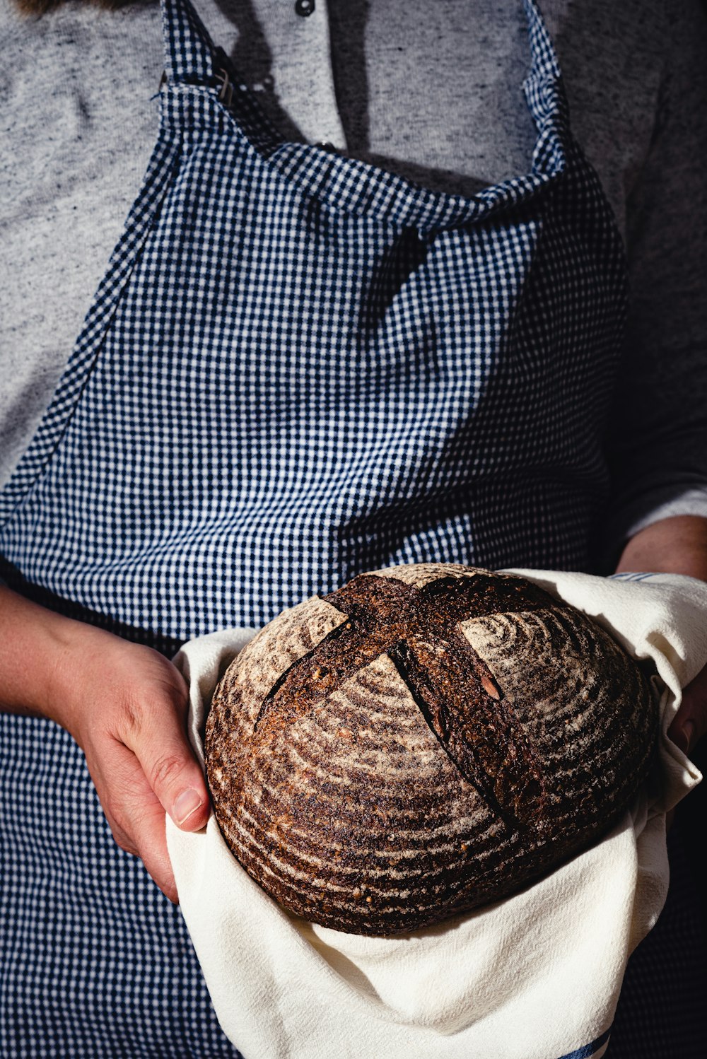 a person holding a loaf of bread in their hands