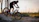 A rider on a LXTEK e-bike cruising through a forest trail at sunset.