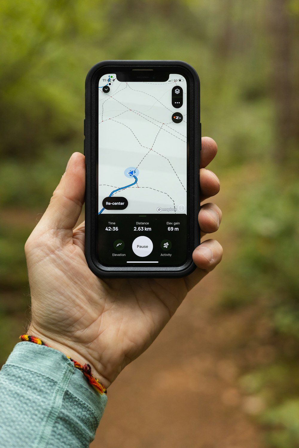 a person holding a cell phone in their hand