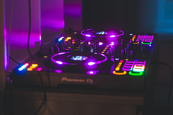 Vibecraft DJ setup glowing with vibrant purple and blue lights at a lively graduation party in Kailua.