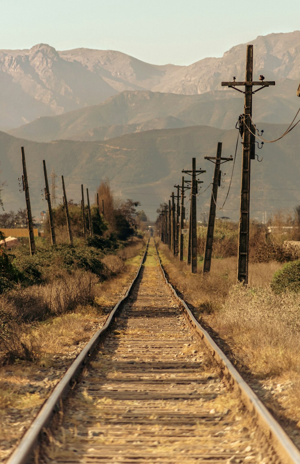 a train track with mountains in the background
