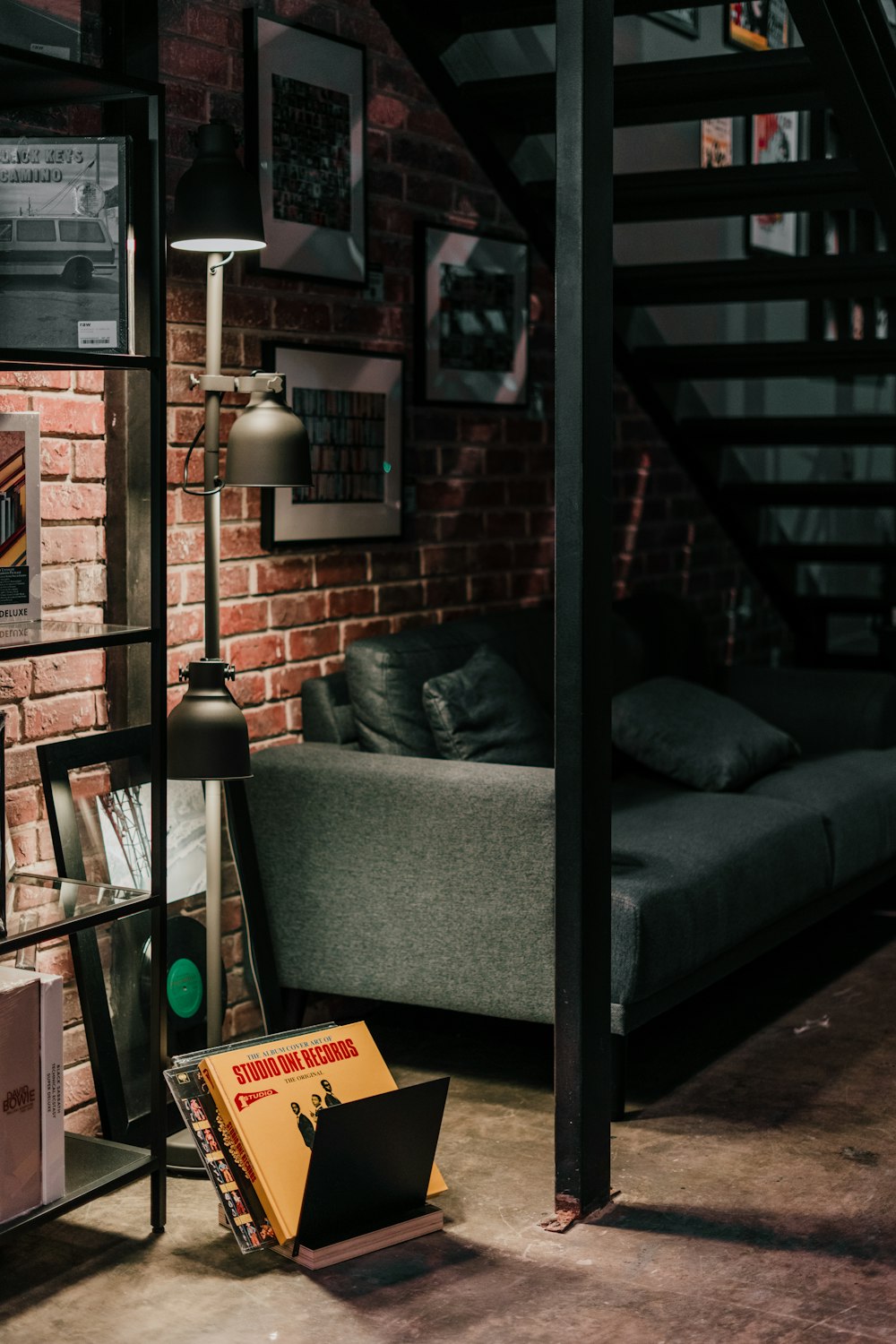 a living room with a couch and a book shelf