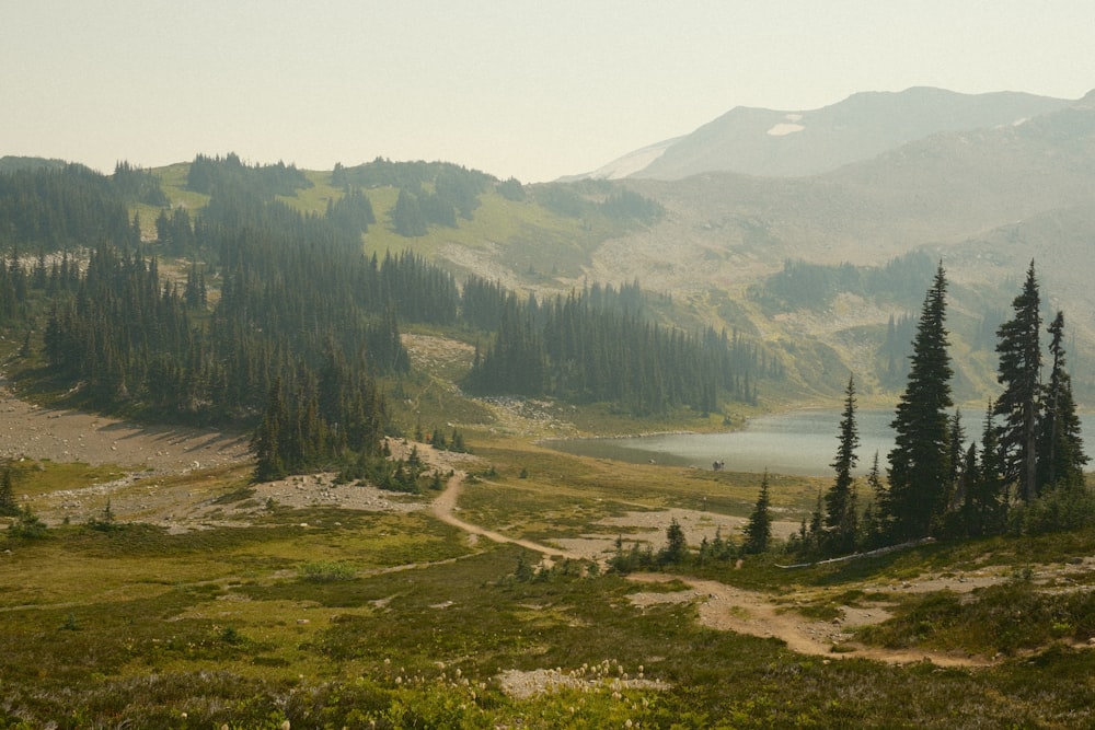 a view of a mountain range with a lake in the foreground