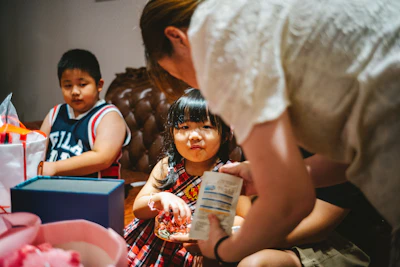 a group of children sitting around a table