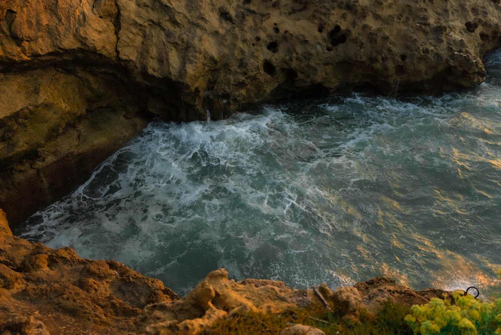 a large body of water near a rocky cliff