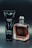 A black tube labeled 'Armani Code' and a clear bottle with amber liquid labeled 'Stronger With You Intensely' are positioned side by side on a dark background.