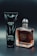 A black tube labeled 'Armani Code' and a clear bottle with amber liquid labeled 'Stronger With You Intensely' are positioned side by side on a dark background.
