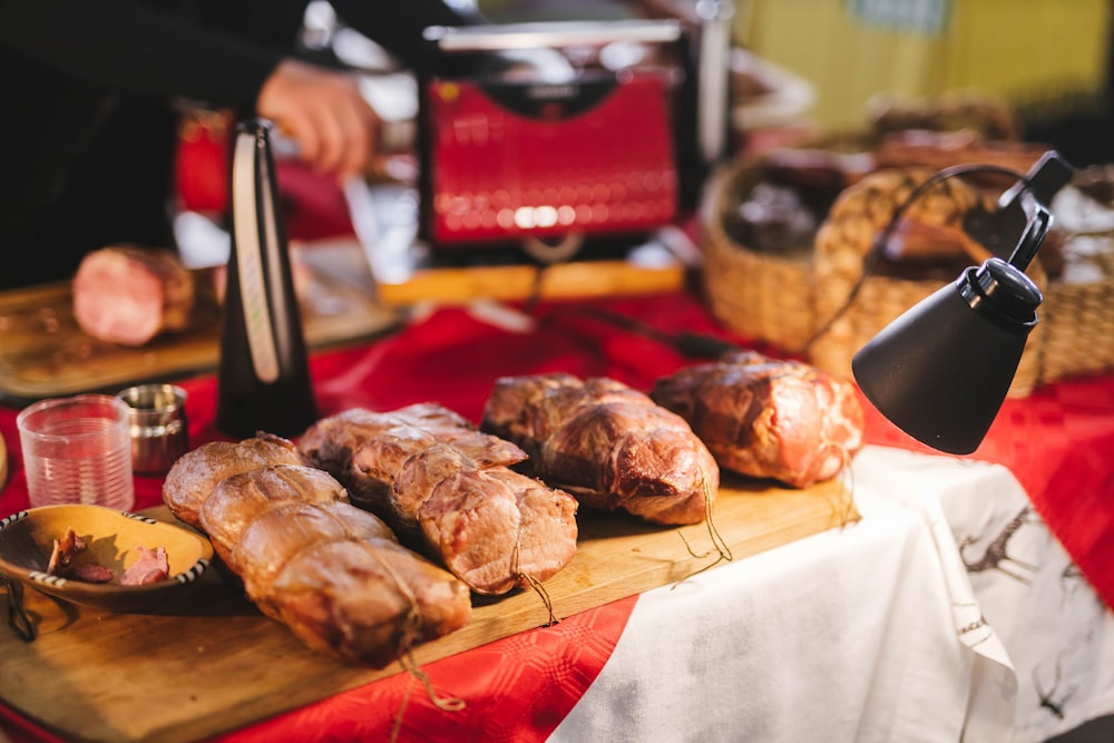 a table topped with bread and pastries on top of a wooden cutting board