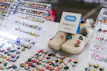A selection of personalized pet tags and charms displayed on a wooden table