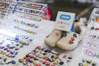 A selection of personalized pet tags and charms displayed on a wooden table