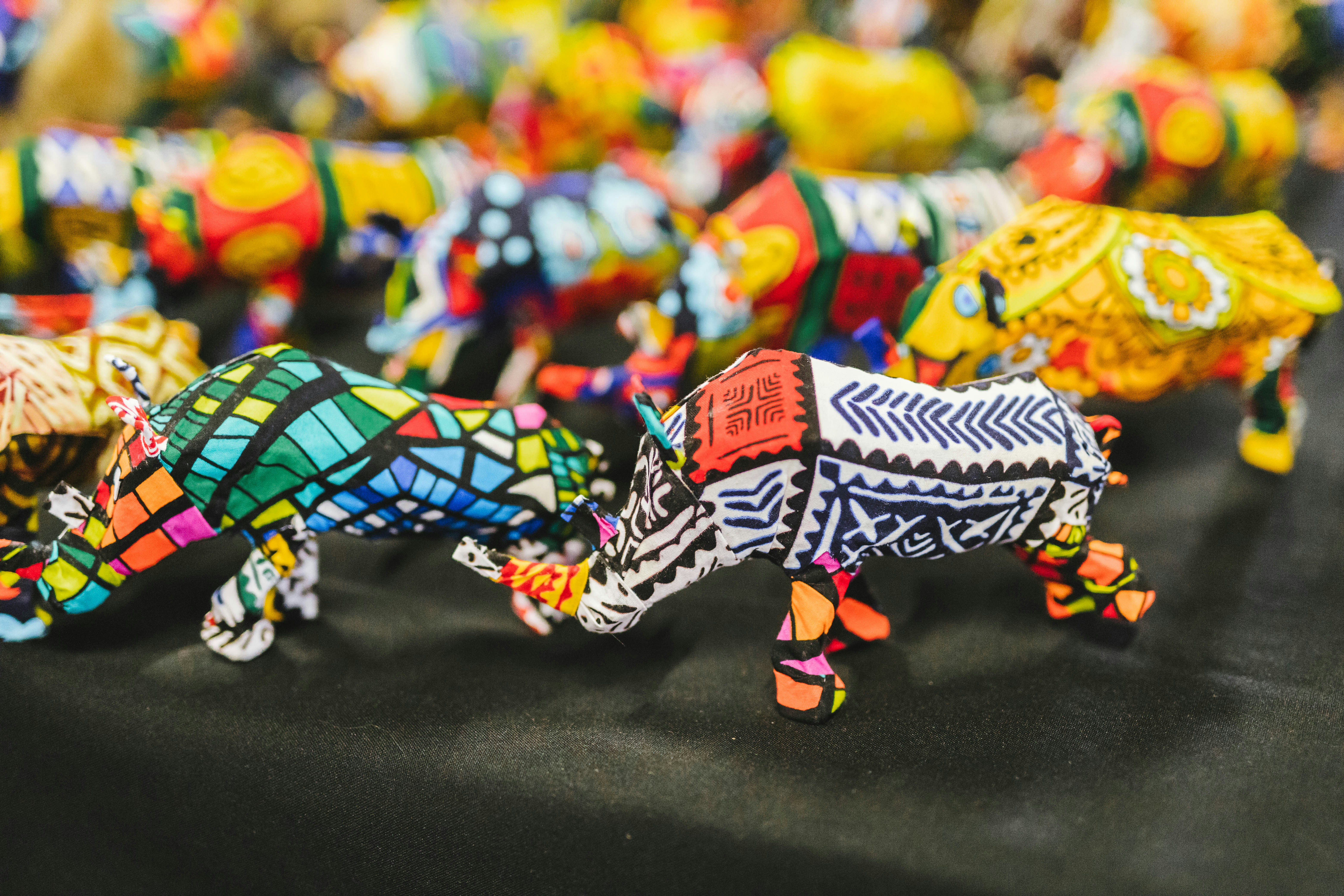 a table topped with lots of colorful glass animals