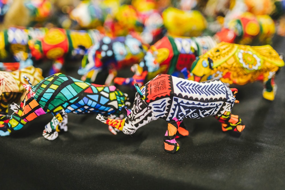 a table topped with lots of colorful glass animals