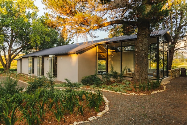 A modern family home with large windows and a landscaped garden.