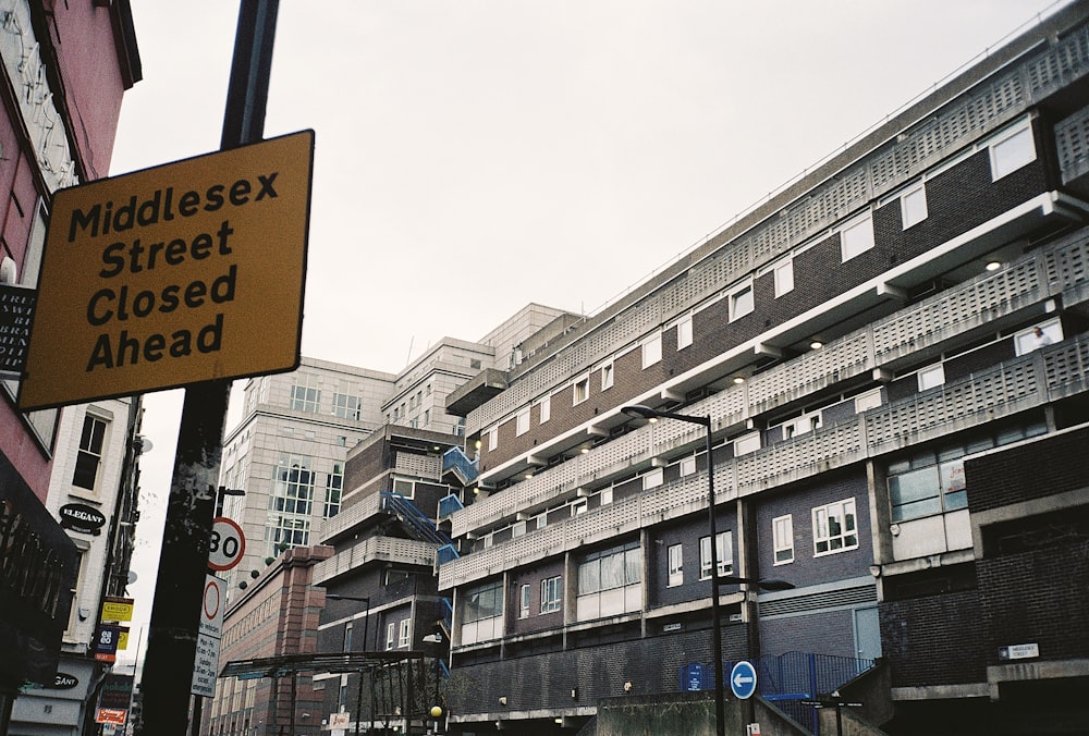 a street sign on a pole in front of some buildings