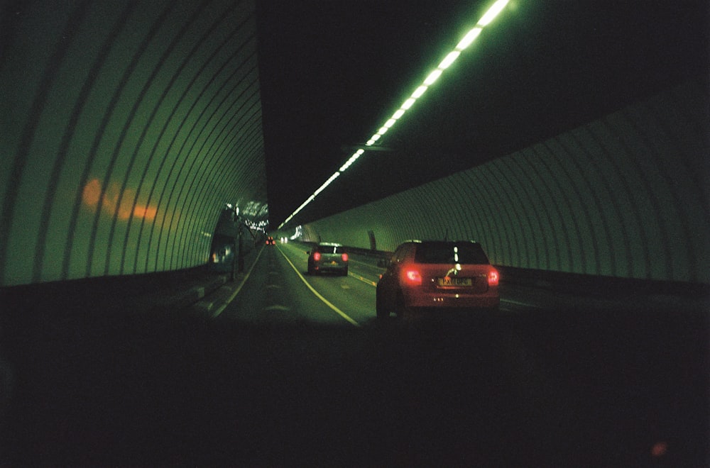 a car driving through a tunnel at night