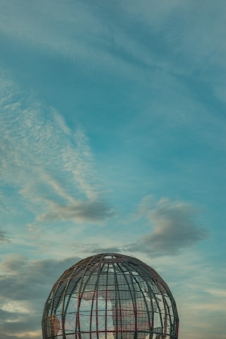 a large metal structure sitting on top of a field