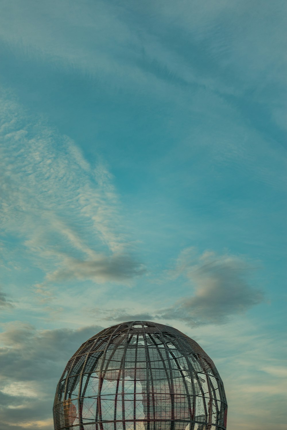 a large metal structure sitting on top of a field