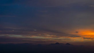 A wall art print made from a customer’s travel snapshot, capturing a sunset over mountains