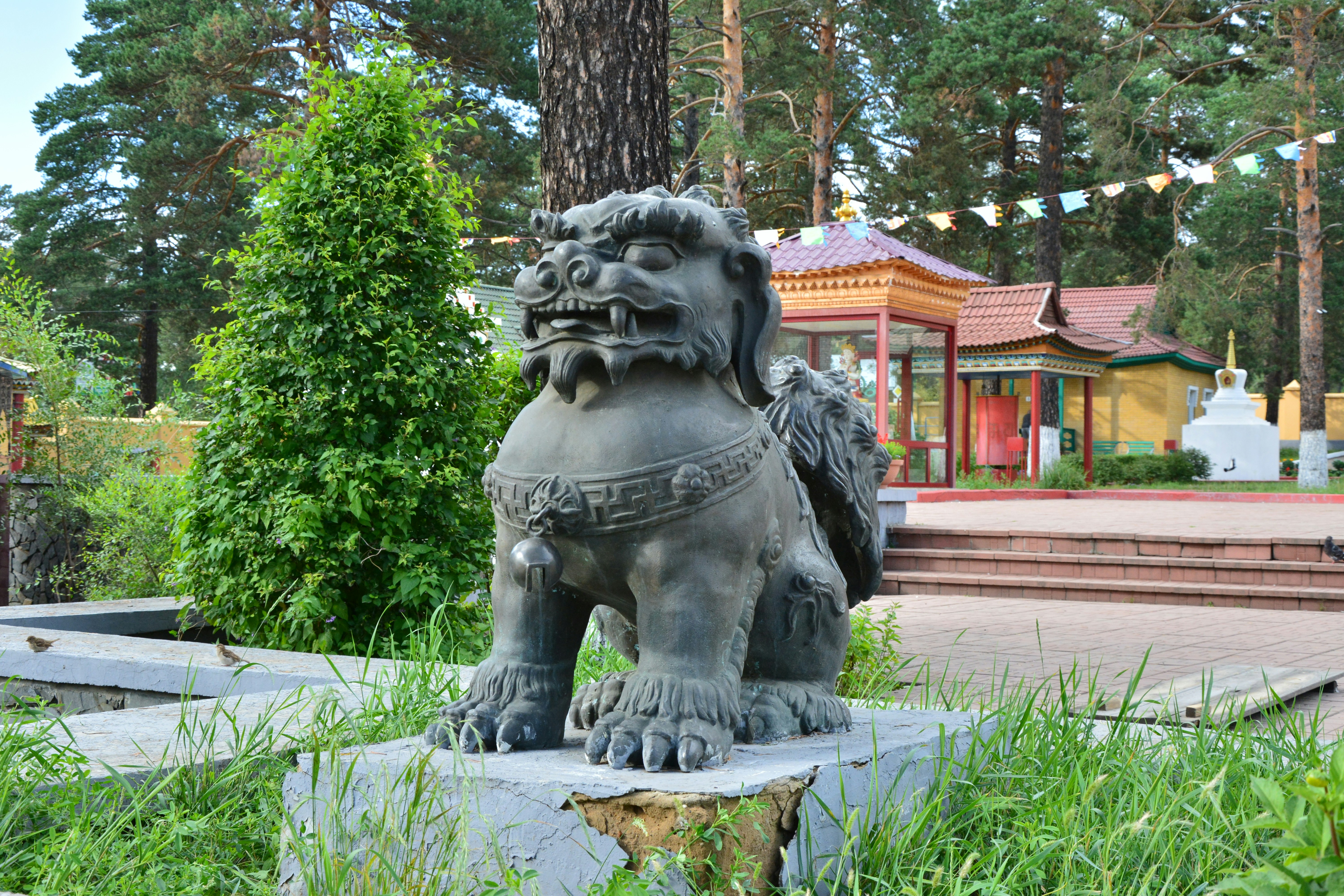 a statue of a lion in a park