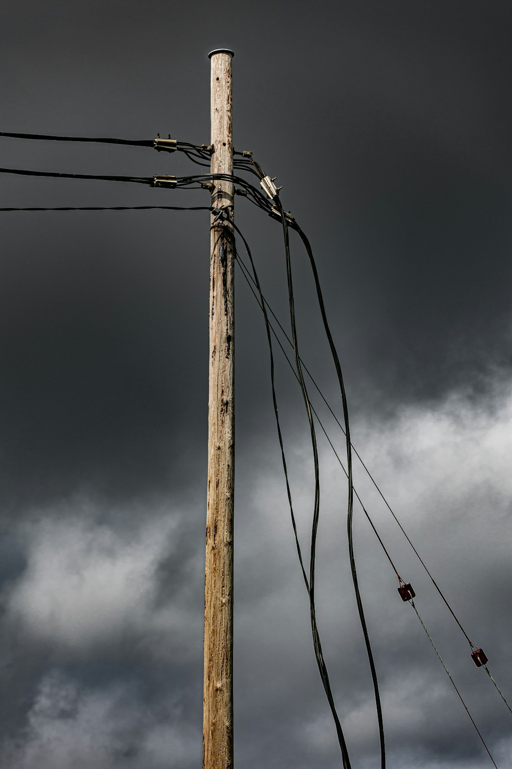 ein Telefonmast, an dem ein Bündel Drähte befestigt ist