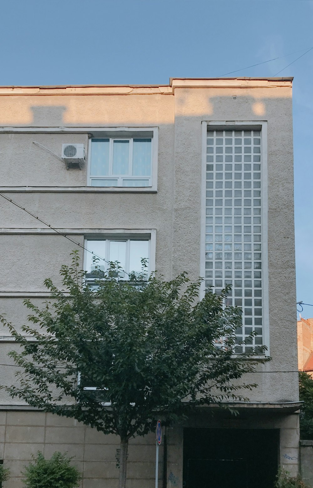 a building with a tree in front of it