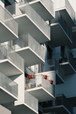 A cozy urban apartment building in Zaragoza with balconies and flower pots.