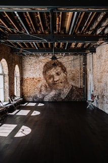 A wide shot of a spacious room featuring a large, elegant mural with minimalist design.