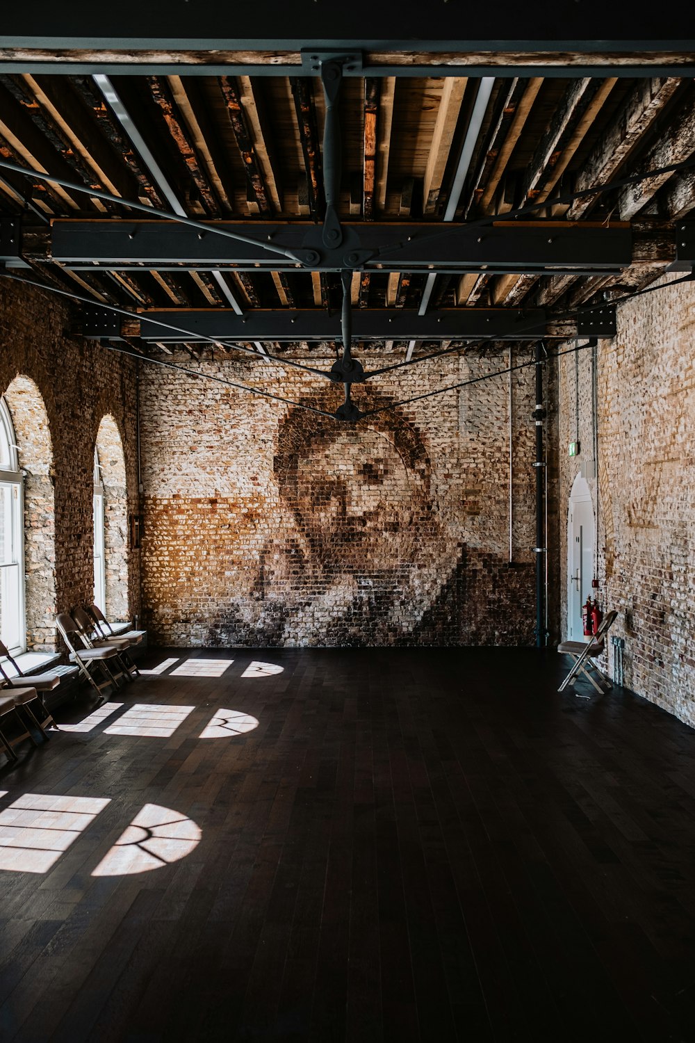 a large room with a mural of a man on the wall