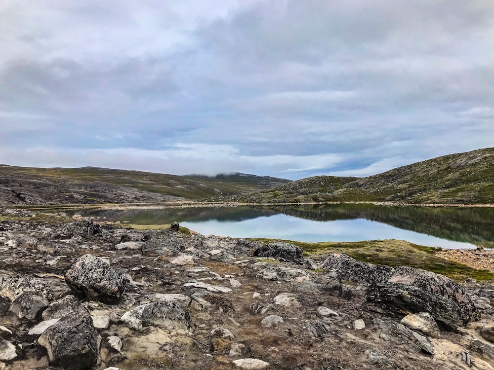 a large body of water surrounded by rocky terrain