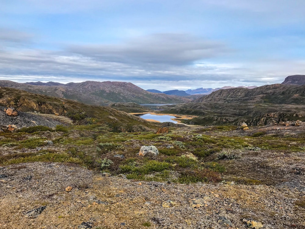 a view of a mountain range with a lake in the distance