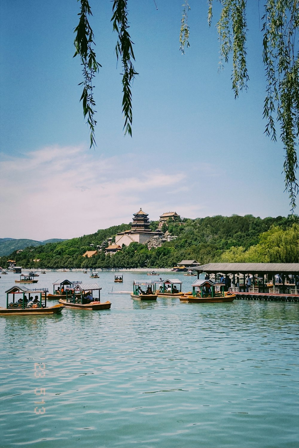 a group of boats floating on top of a lake