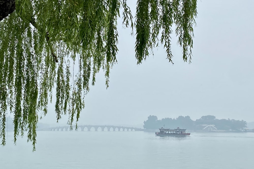 a boat on the water with a bridge in the background