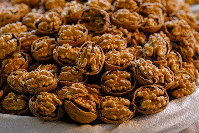 Fresh walnuts with shells cracked open, showcasing their creamy texture.