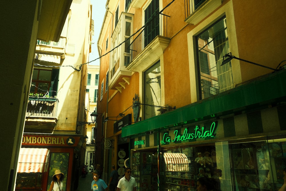 a group of people walking down a street next to tall buildings