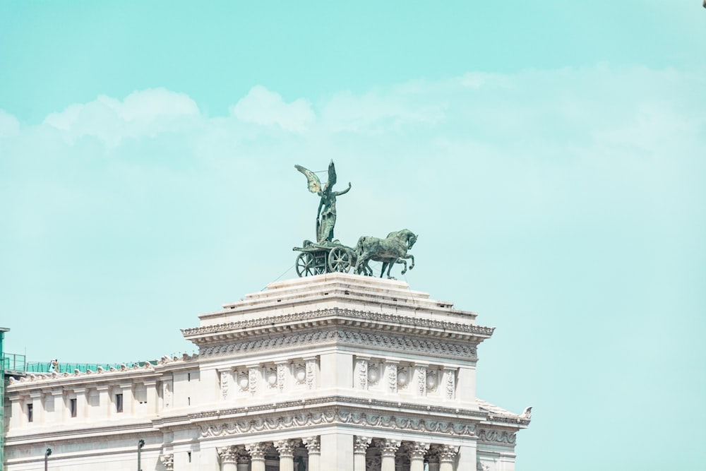 a statue of a man on a horse on top of a building