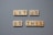 Wooden tiles with black letters spell out the motivational phrase 'LET US DO THIS' arranged on a gray background.
