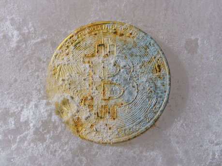 a dirty round object sitting on a white surface