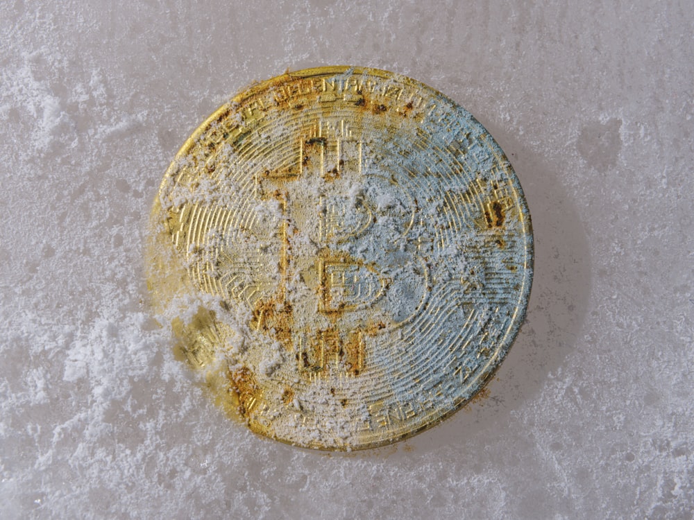 a dirty round object sitting on a white surface