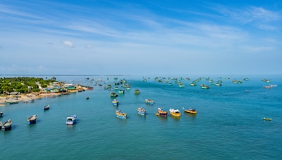 A serene view of the fishing village with colorful boats and calm waters.
