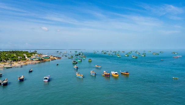 A serene morning at a coastal village with fishermen preparing their boats.