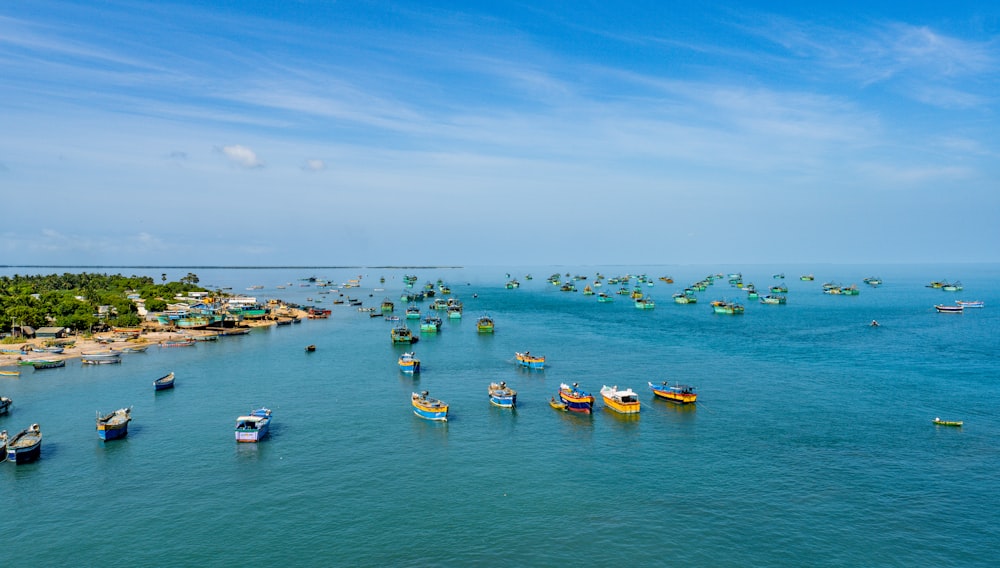 a group of boats floating on top of a body of water