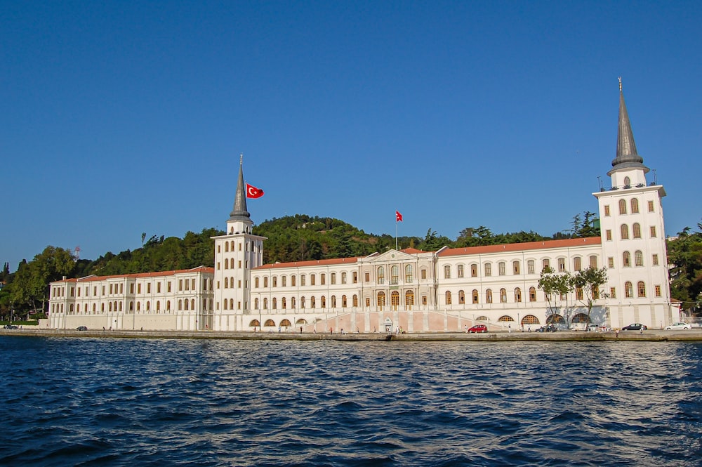 a large white building sitting on top of a body of water