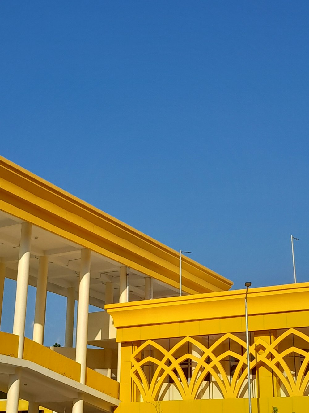 a yellow building with a clock on the front of it