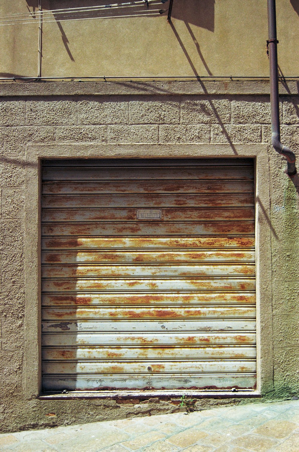 a closed garage door on the side of a building
