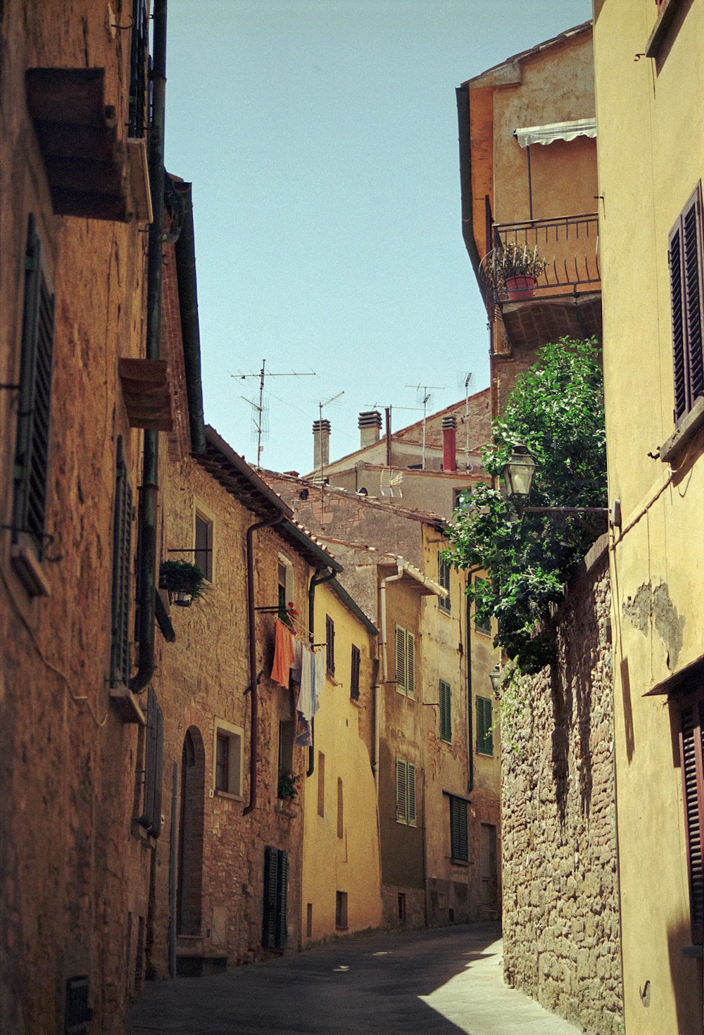 a narrow street with buildings and clothes hanging on a line