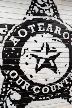 A colorful mural depicting Pasifika culture on a building wall in Kaitaia.