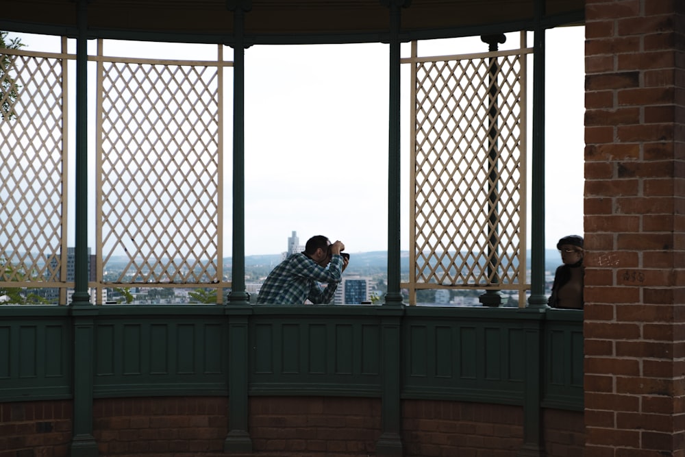 a couple of people that are standing on a balcony