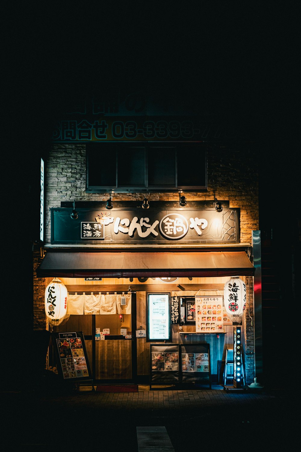 a restaurant with a neon sign on the front of it