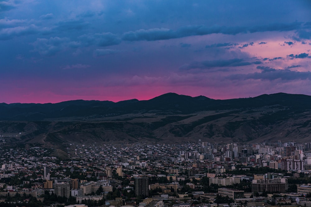 a view of a city with mountains in the background