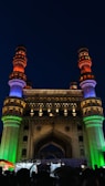 A historic monument illuminated at night.